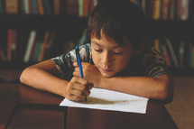 Boy drawing in a library