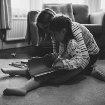 a mother reading a Children's Bible with her daughter 