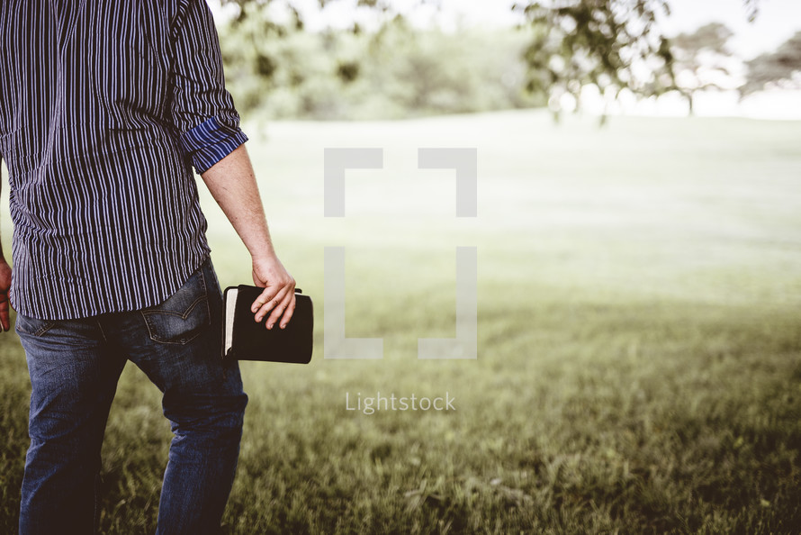 man carrying a Bible 