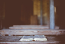 opened Bible on benches 