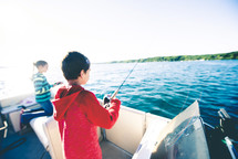 children fishing on a boat 