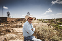 rancher sitting in a desert landscape 