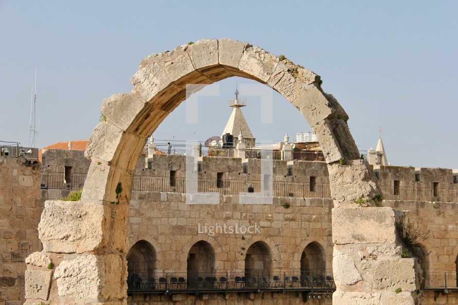 Walls of old city Jerusalem and stone arch 