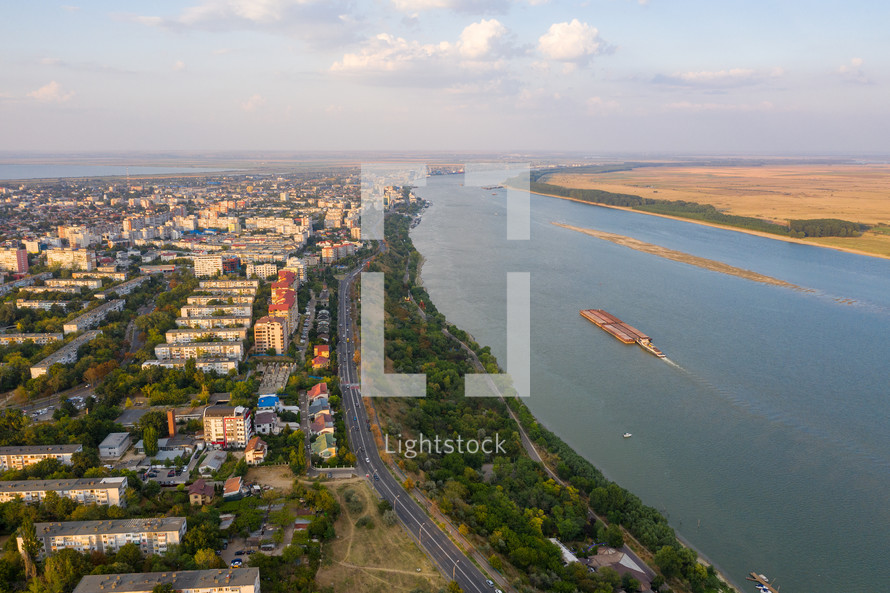 Aerial view of Galati City, Romania. Danube River near city with sunset warm light