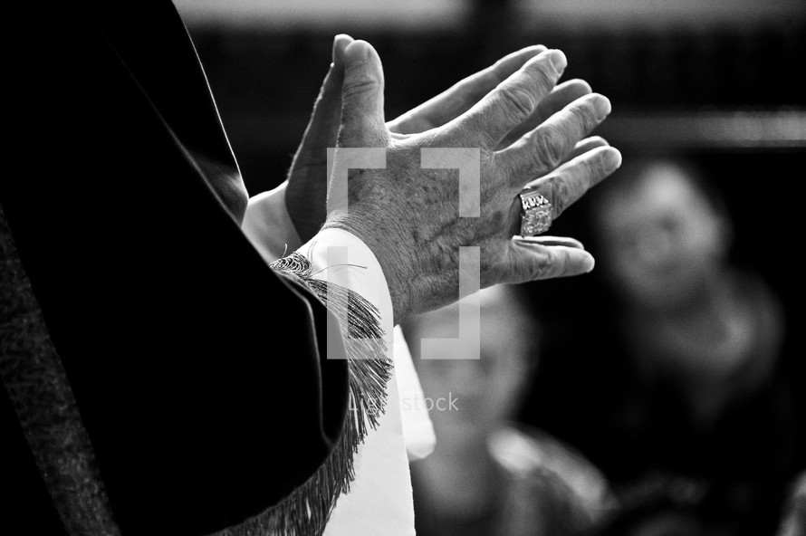 priest with praying hands 