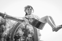 a child swinging on a swing 