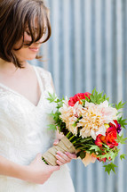 A bride holding a wedding bride bouquet burlap white dress