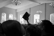 packed church and raised Bible 
