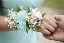wrist corsage and holding hands