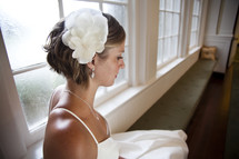bride sitting on a window bench