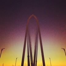 Sunset behind a large bridge