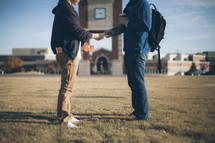 A man handing out a tract on a college campus