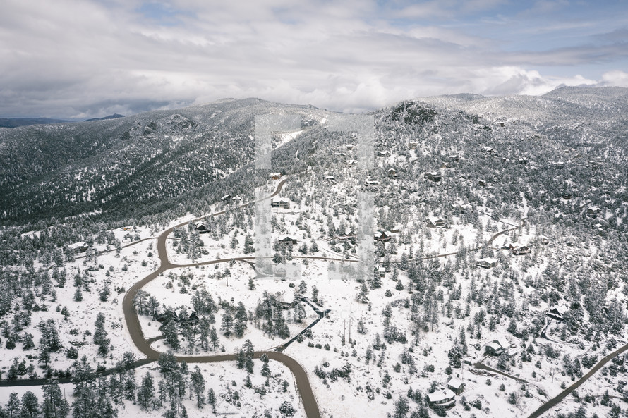 Aerial view of winding snowy road in mountains