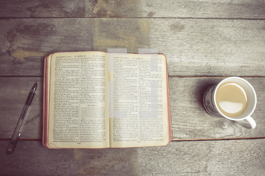 pen, opened Bible, and coffee cup 