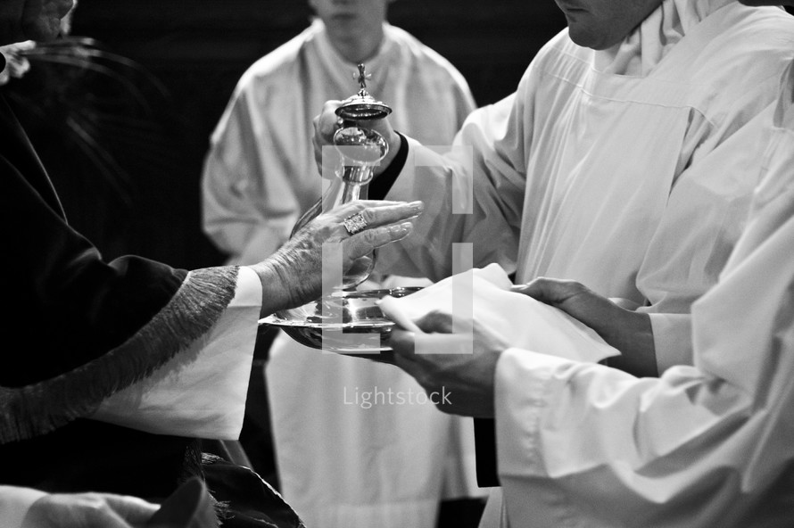 priests preparing communion 