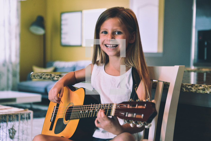 a girl playing a guitar 