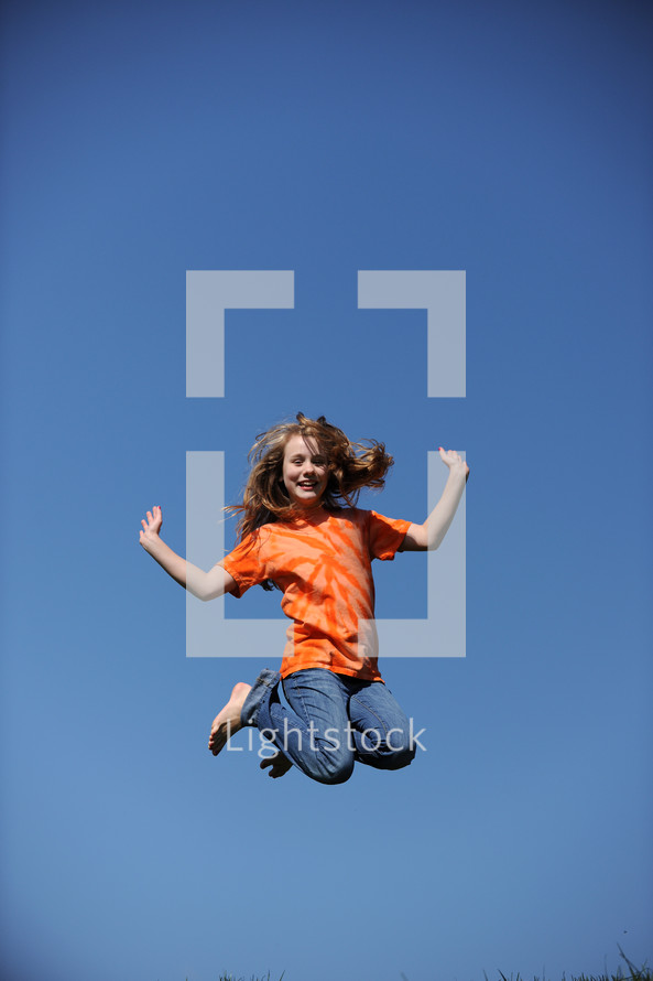 girl child jumping in the air 