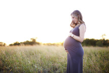 Pregnant woman in grass field