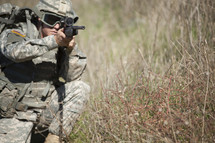 Military man aiming a rifle.