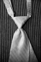 a man's tie hanging over a chair