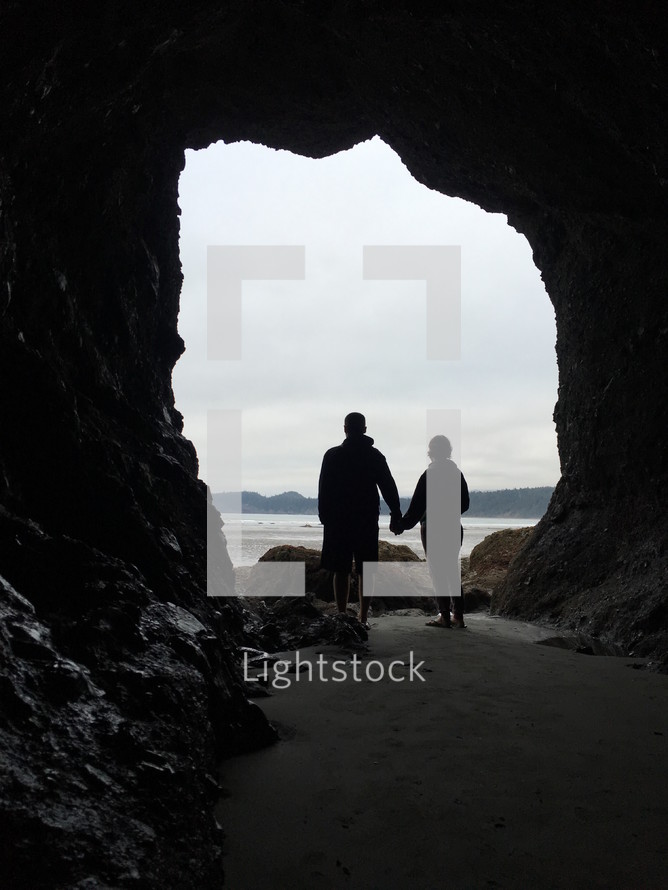 couple standing in a cave 