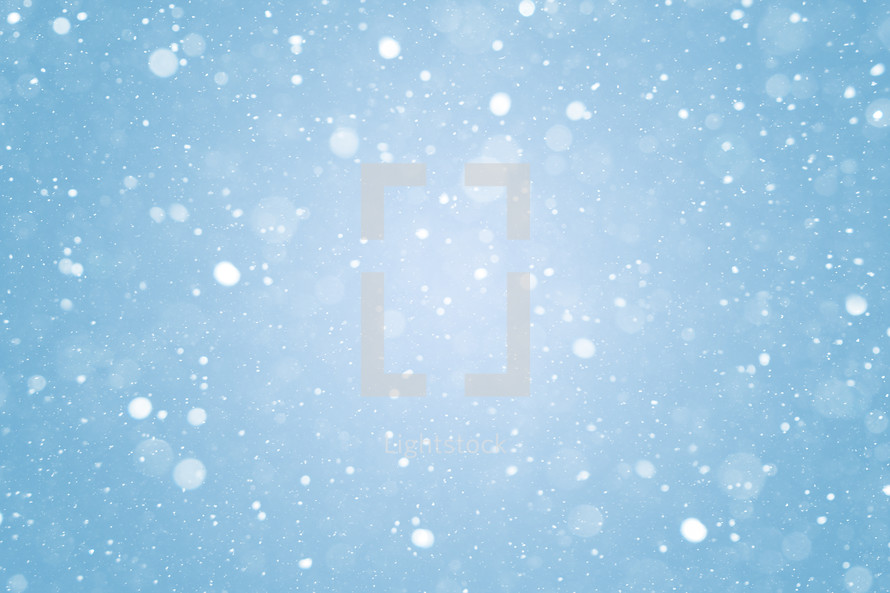 Falling snow icy winter bokeh lights and snowflakes abstract backdrop. Snowing frozen blizzard background texture.