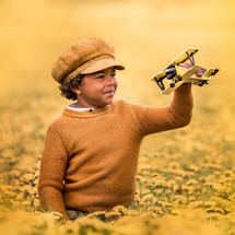 a boy with a toy airplane 