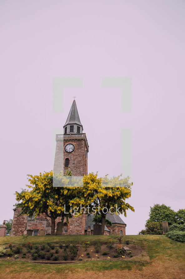 rural brick church with steeple on a hill in Scotland 