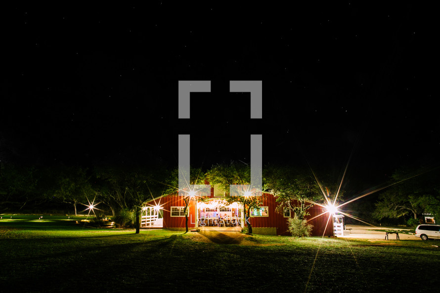 A red barn at night used for an outdoor wedding reception. 