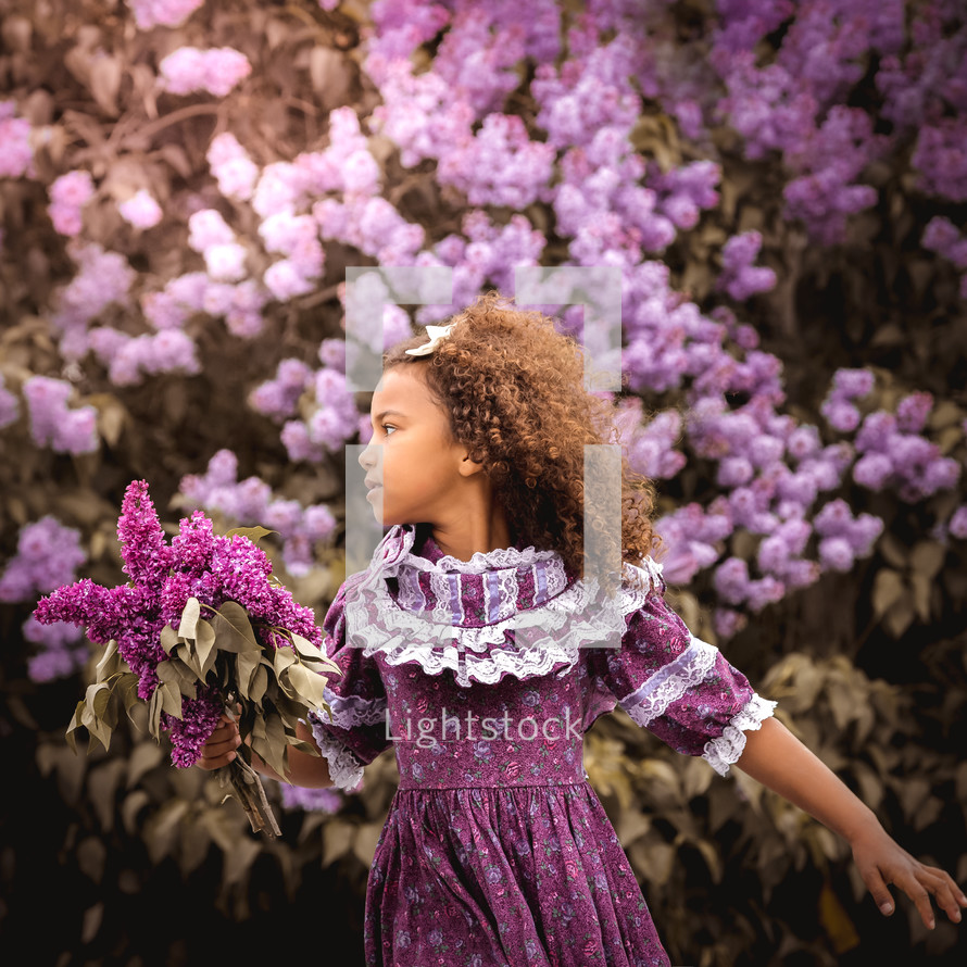 girl surrounded by purple flowers 