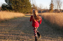 girl running in a field 