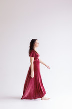 Woman walking in a dress on a white background 