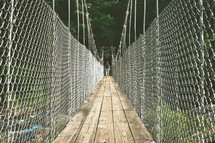 chain link fence along the side of a swinging bridge 