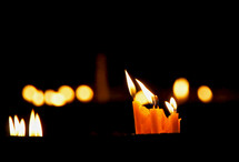 Burning candles illuminate the darkness