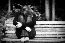depression - woman sitting on a bench 