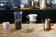 coffee items on a wood countertop in a coffee shop 
