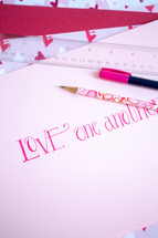 Valentine's day themed pencils on a white background 