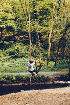 a child on a rope swing 