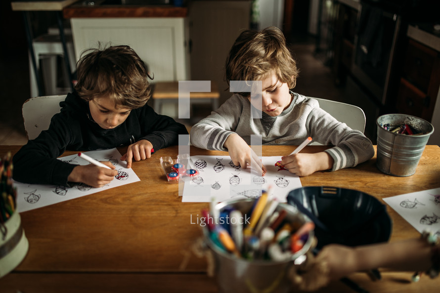 children coloring a coloring page at home 