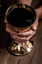 priest with a chalice at eucharist 