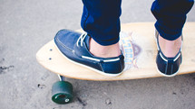 feet of a boy on a skateboard 