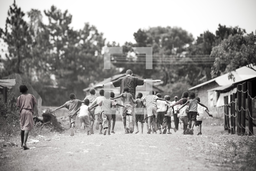 Man walking with children in village