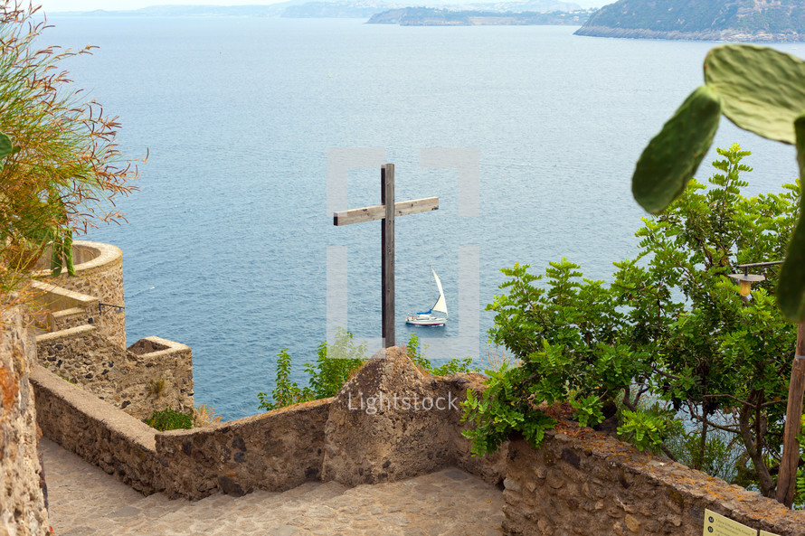 Wooden crucifix in the Aragonese Castle sheer above the sea