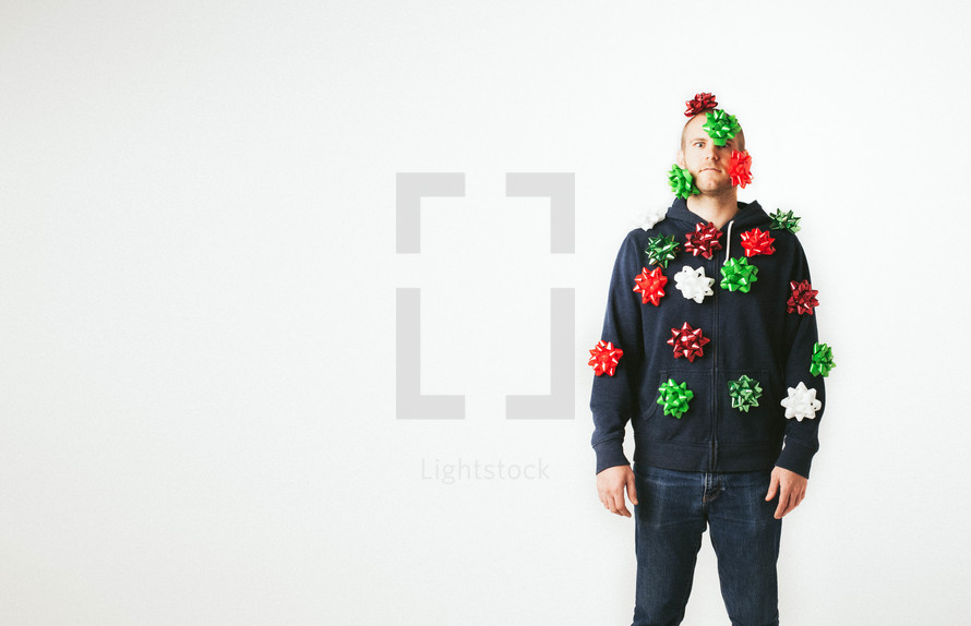 A man covered in Christmas bows