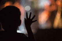 silhouette of a little boy at a concert 