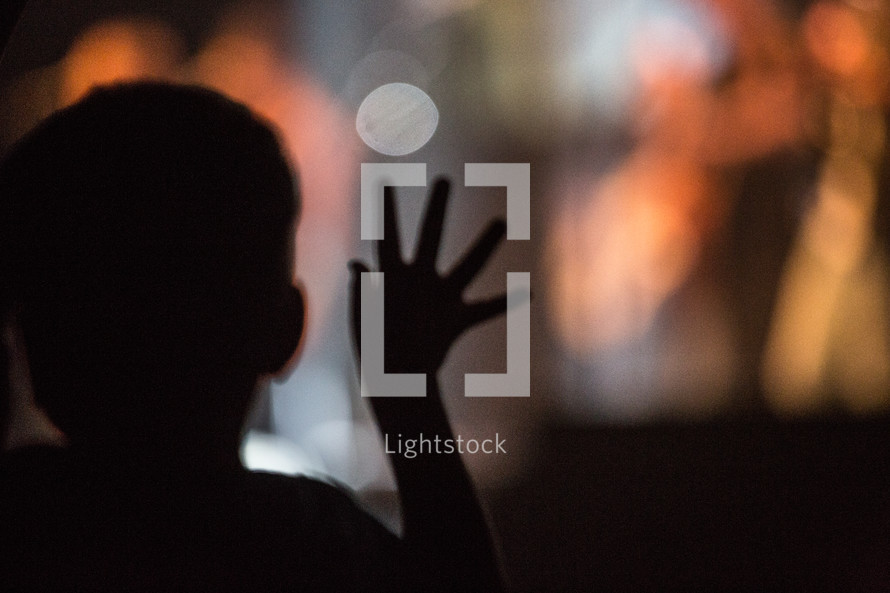 silhouette of a little boy at a concert 