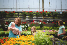 sisters picking out flowers at a garden center 