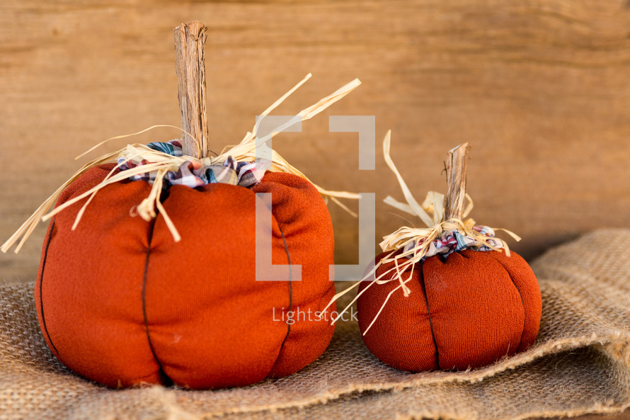 orange fabric pumpkins on burlap