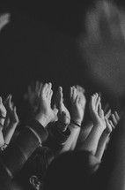 Raised hands at a worship service. 