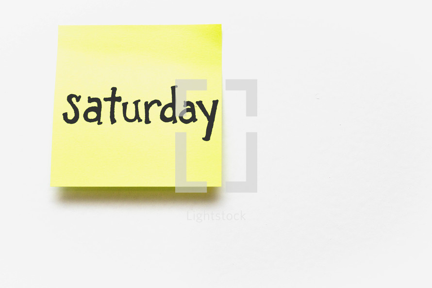 A yellow sticky note with "saturday" written in black ink.